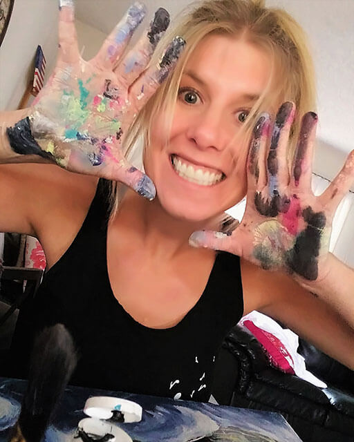 rachel bolka, freelance web designer and web developer head shot image with her hands covered in paint from painting and being creative.